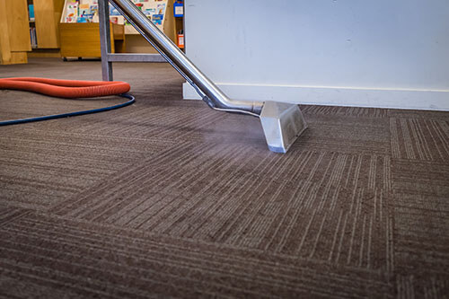How often should commercial carpets be professionally cleaned?